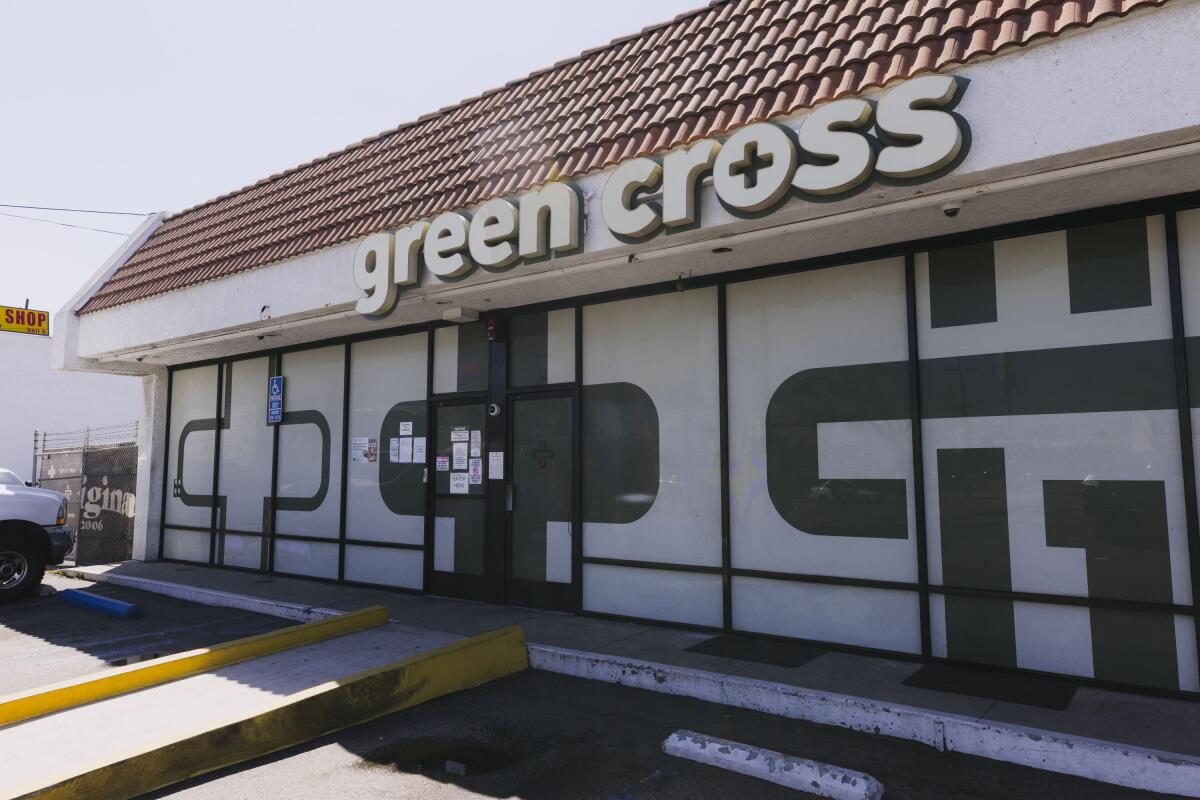 The words "green cross" appear on the front of a building.