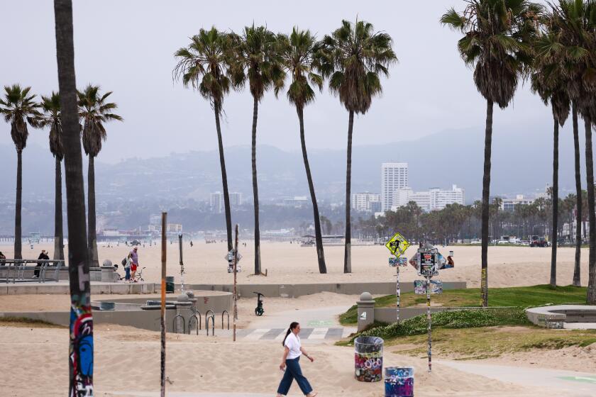 Venice, CA - June 03: Beachgoers under cloudy skies in a view toward Santa Monica on Monday, June 3, 2024 in Venice, CA. (Brian van der Brug / Los Angeles Times)