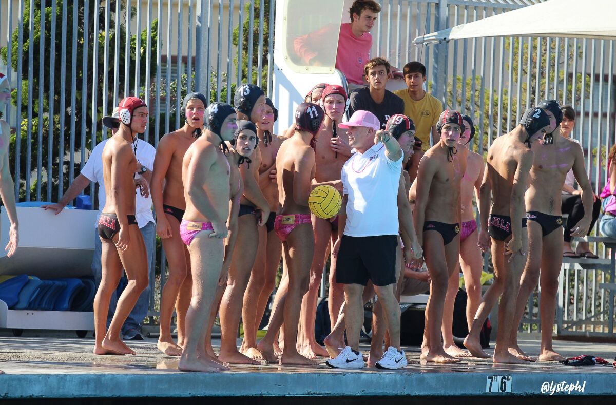 Coach Tom Atwell (in white) gives direction to the La Jolla High boys water polo team during the "Tangle in the Tank."