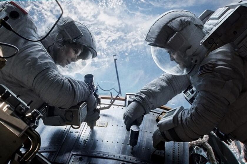 This publicity photo courtesy of Warner Bros. Pictures shows Sandra Bullock, left, as Dr. Ryan Stone and George Clooney as Matt Kowalsky in Warner Bros. Pictures¿ sci-fi thriller ¿Gravity."