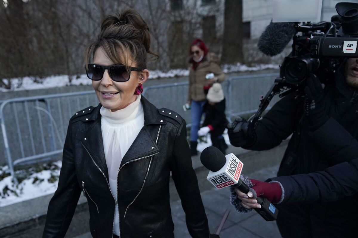Former Alaska Gov. Sarah Palin leaves a courthouse in New York, Monday, Feb. 14, 2022. A judge said Monday he’ll dismiss a libel lawsuit that Palin filed against The New York Times, claiming the newspaper damaged her reputation with an editorial falsely linking her campaign rhetoric to a mass shooting. U.S. District Judge Jed Rakoff made the ruling with a jury still deliberating in the trial where the former Alaska governor and vice-presidential candidate testified last week. (AP Photo/Seth Wenig)