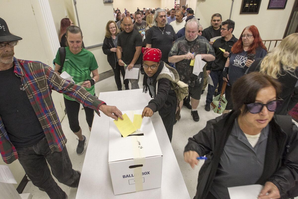 Grocery store workers from Ralphs, Vons and Albertsons deposited their ballots after voting Monday on whether to authorize a strike should future negotiations stall. The vote was the first of three sessions held at the Scottish Rite Center by UFCW 135.