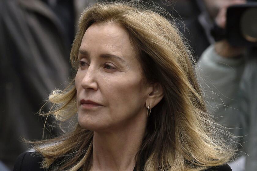 Felicity Huffman arrives at federal court Monday, May 13, 2019, in Boston, where she is scheduled to plead guilty to charges in a nationwide college admissions bribery scandal. (AP Photo/Steven Senne)