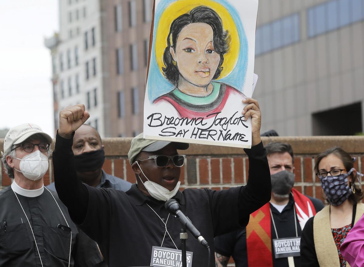 Kevin Peterson displays a placard with an image Breonna Taylor at a Boston rally on June 9.