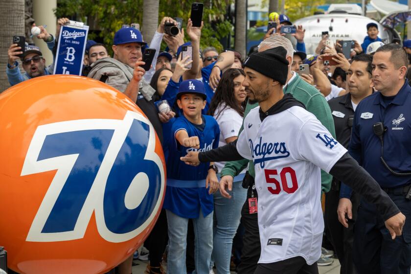 \Los Angeles, CA - February 03: Dodger Mookie Betts fist bumps fan Andrew Ruiz, 12, at DodgerFest 2024, the official kickoff celebration for the upcoming season of Dodger baseball at Dodger Stadium on Saturday, Feb. 3, 2024 in Los Angeles, CA. (Brian van der Brug / Los Angeles Times)
