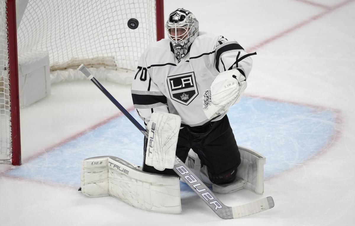 Kings goalie Joonas Korpisalo swats the puck away during the third period of the team's game against the Colorado Avalanche 