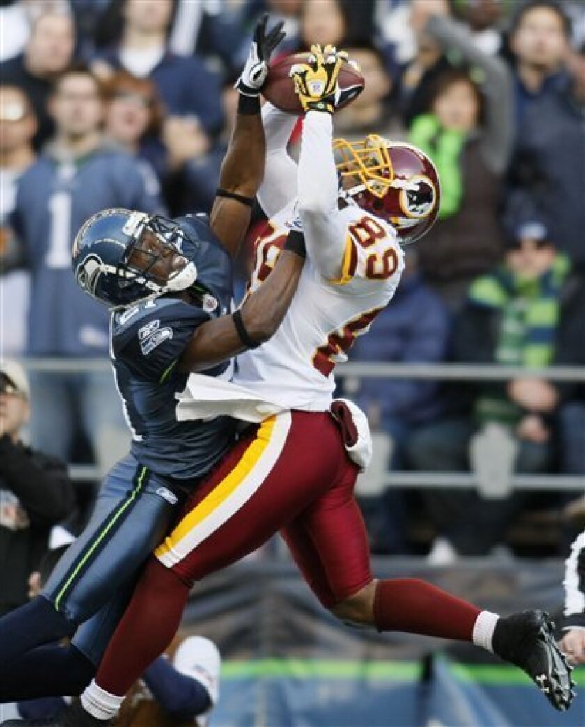 Washington Redskins wide receiver Santana Moss catches a pass with Seattle Seahawks cornerback Kelly Jennings defending during the second quarter of an NFL football game Sunday, Nov. 23, 2008, in Seattle. Jennings was called for interference, setting up a touchdown for Washington. (AP Photo/John Froschauer)
