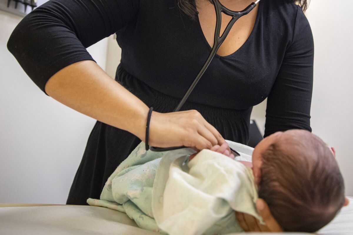 Doctor examining an infant