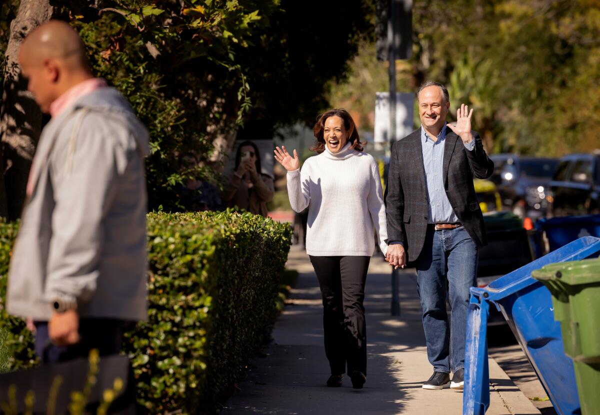 Vice President Kamala Harris and Second Gentleman Doug Emhoff walk through their neighborhood in Los Angeles on Nov. 21.