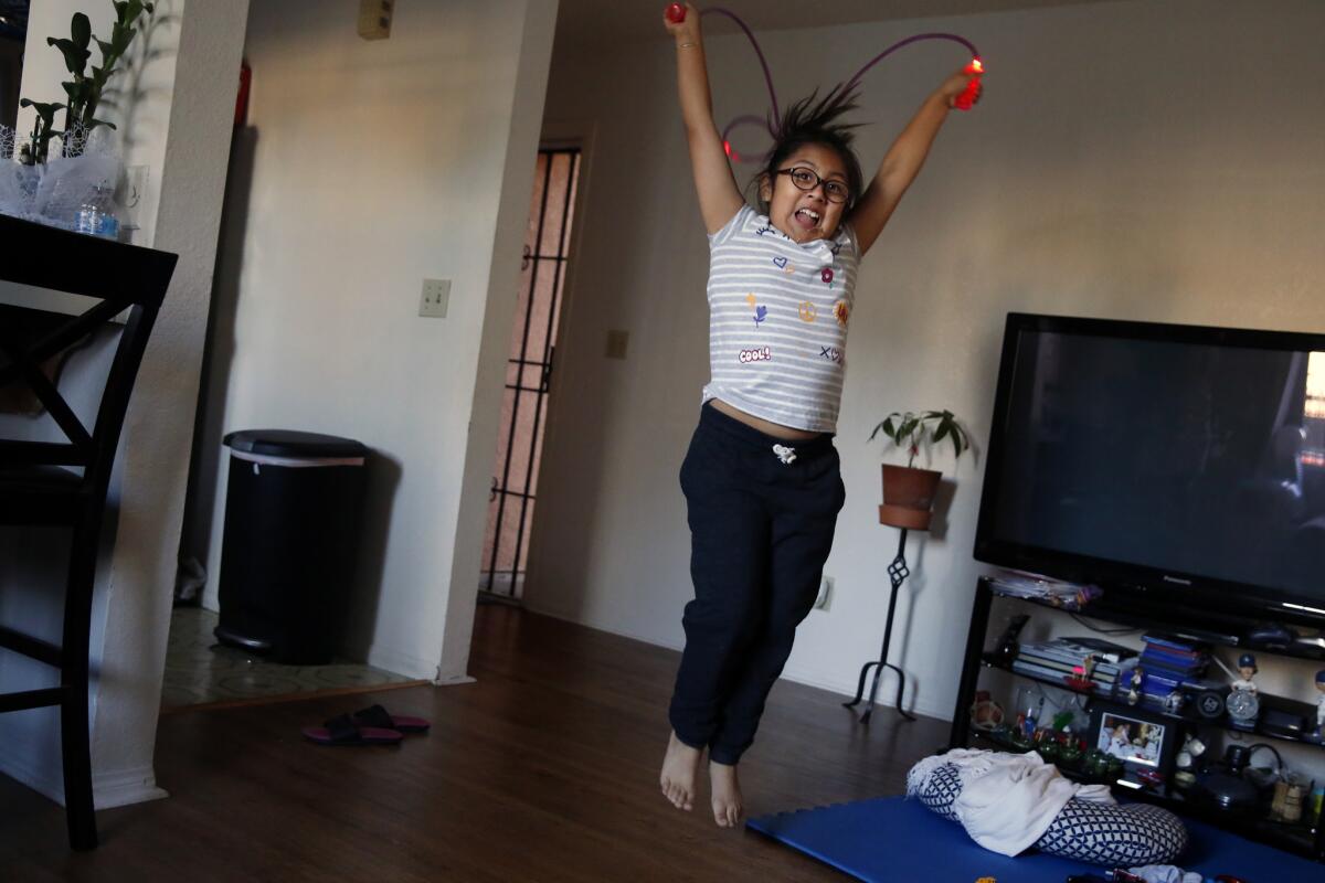 Irie Mazas jump ropes after dinner. (Dania Maxwell / Los Angeles Times)