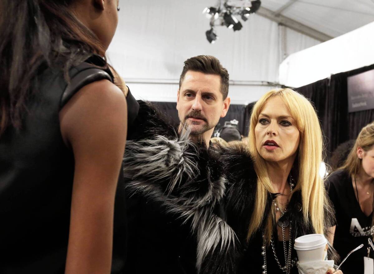Designer Rachel Zoe and colleague Michael Ward check a design backstage before her fall 2013 collection is modeled during Fashion Week in New York in February 2013.