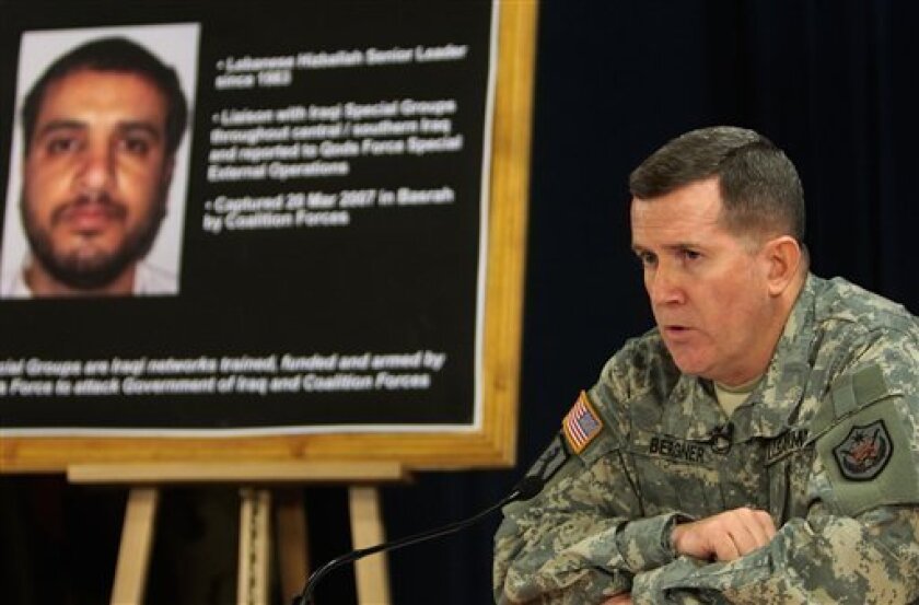 FILE - In this July 2, 2007 file photo, U.S. military spokesman Brig. Gen. Kevin J. Bergner speaks during a press conference in Baghdad, Iraq, near a poster of a senior Lebanese Hezbollah operative Ali Mussa Daqduq. The U.S. believes Daqduq is a top threat to Americans in the Mideast, and had asked to extradite him even before two Iraqi courts found him not guilty of masterminding the 2007 raid on a military base in the holy Shiite city of Karbala. (AP Photo/Wathiq Khuzaie, Pool, File)