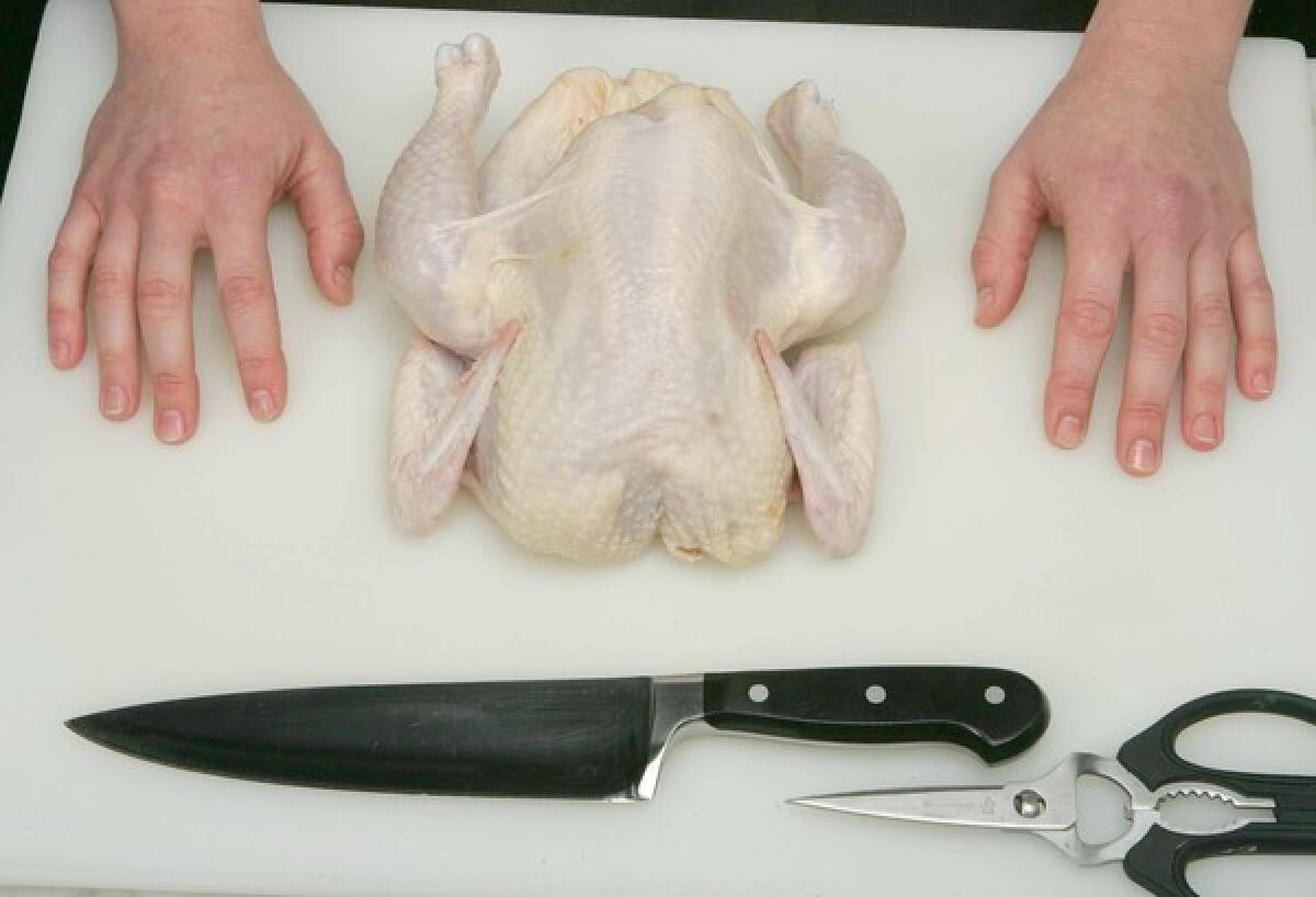 Cutting up a whole chicken.