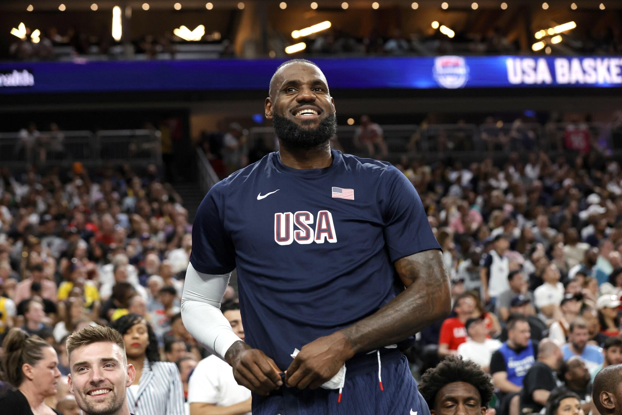 Team USA forward LeBron James stands near the bench in his warmups during the an exhibition game against Canada on Wednesday.