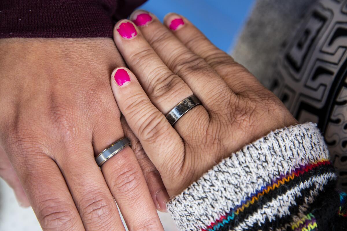 Two hands with matching rings