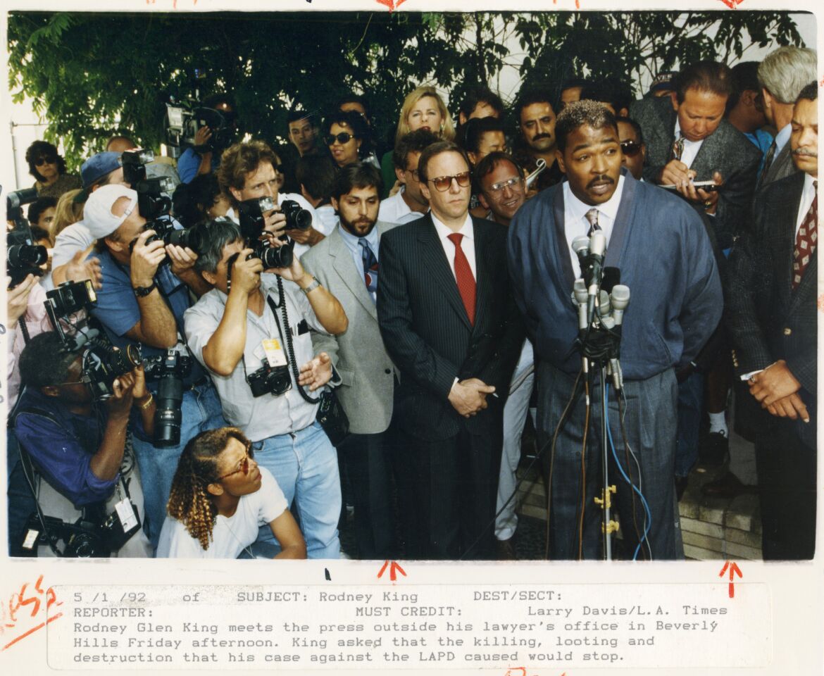 Rodney King asks the now-famous question, "Can we all get along?" in a press conference outside his lawyer's office in Beverly Hills. King asked that the killing, looting and destruction spurred by his case would stop.