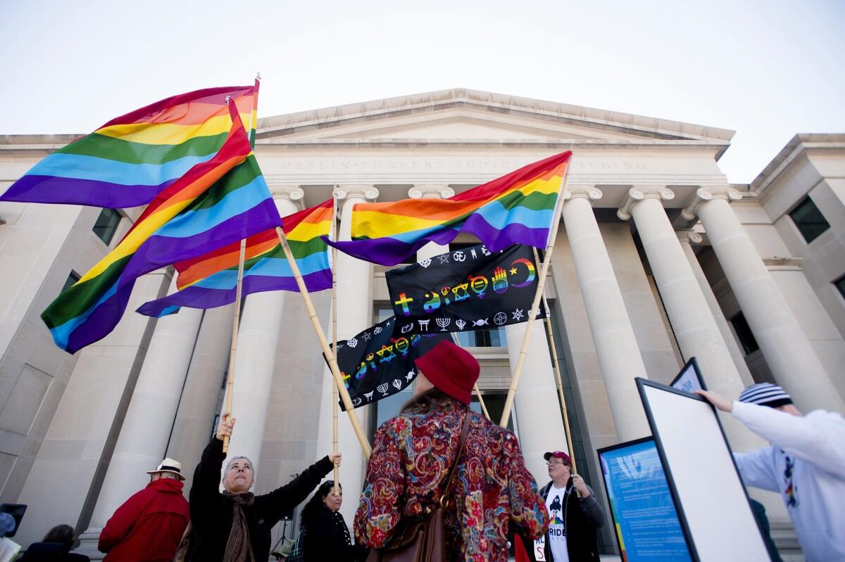 Minoo Vafai, left, and others rally in support of same-sex marriage outside the Alabama Supreme Court in Montgomery in January.