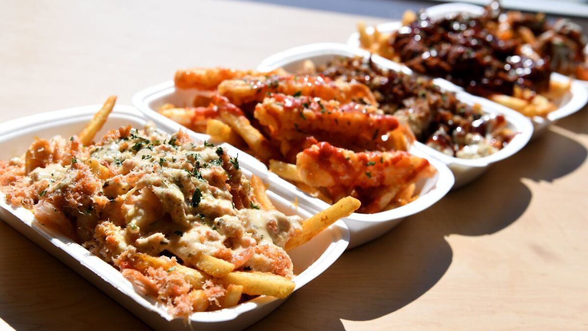 Lemon garlic snow crab fries, left, along with other choices at Mr. Fries Man in Gardena.