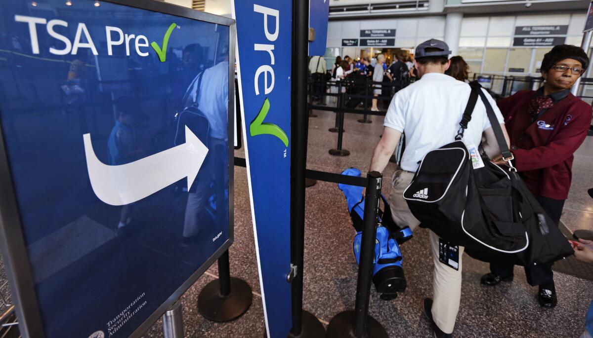 FILE - A passenger passes by a sign for the Transportation Security Administration's TSA PreCheck line in Terminal A at Logan Airport in Boston, Monday, June 27, 2016. Air travelers are finally getting a break on fares. The government said Wednesday, Aug. 10, 2022, that the average airfare dropped nearly 8% in July compared with June, to $311. (AP Photo/Charles Krupa, File)