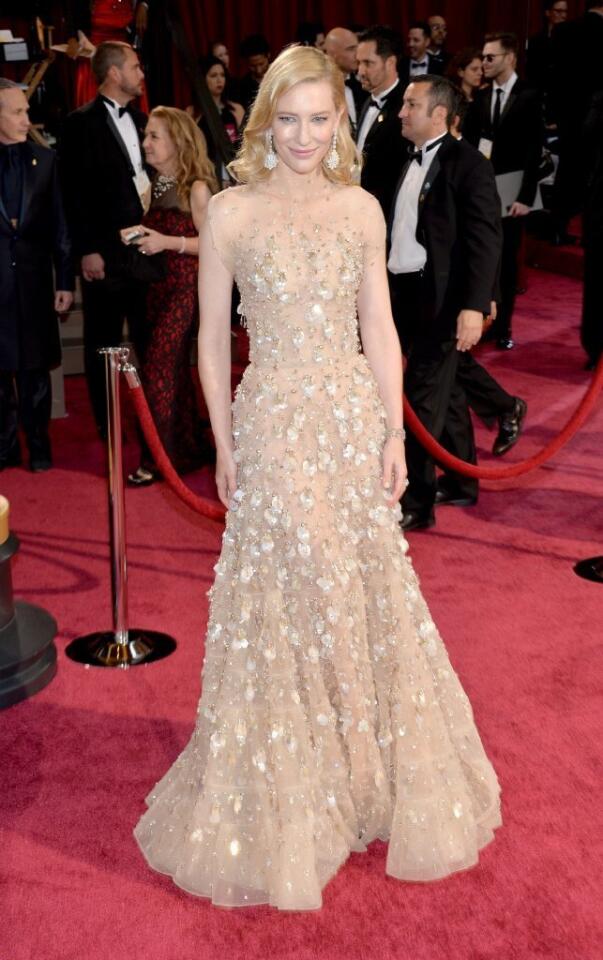 Actress Cate Blanchett wore a gold-colored gown by Armani Prive on the 2014 Academy Awards red carpet.