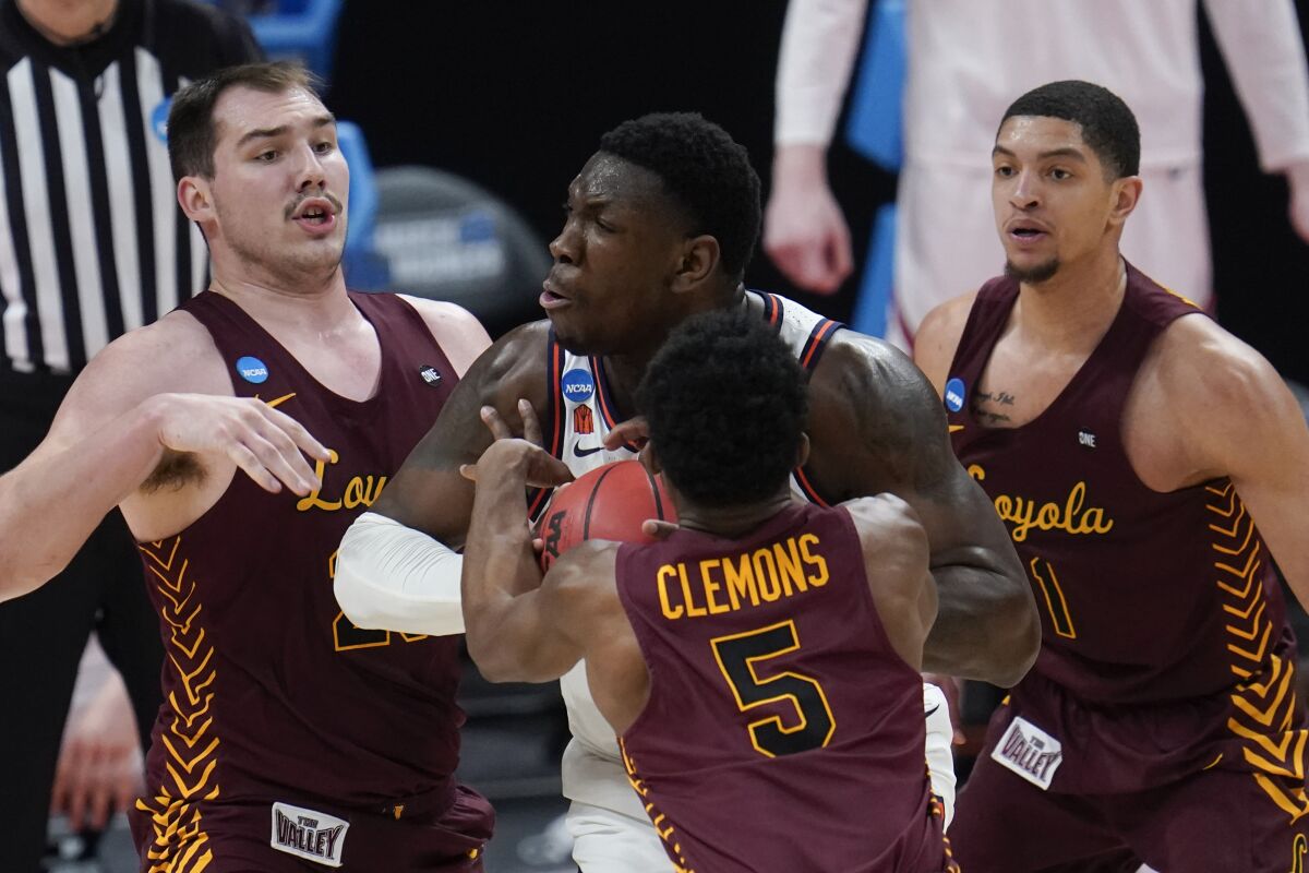 Three Loyola Chicago players surround an Illinois player who has the ball.