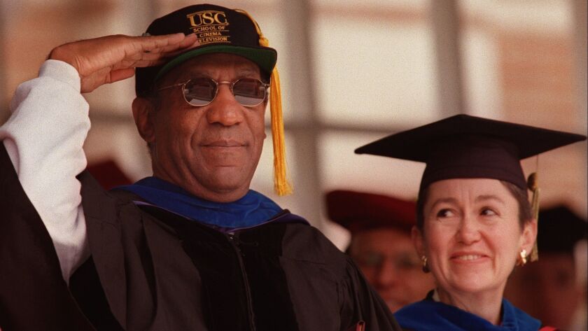 Entertainer Bill Cosby salutes graduates after receiving an honorary degree and speaking during graduation ceremonies at USC in Los Angeles on May 8, 1998.