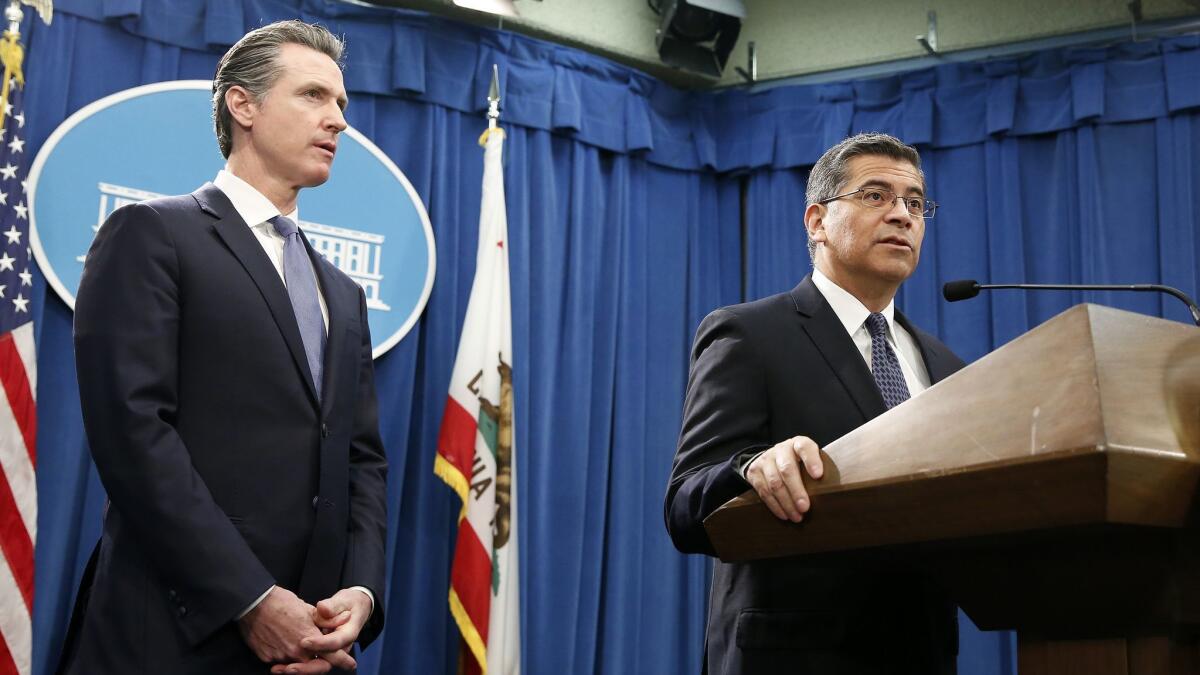 California Atty. Gen. Xavier Becerra, right, and Gov. Gavin Newsom are leading a multi-state lawsuit over the Trump administration's emergency declaration to fund a border wall. Legal experts disagree on whether the lawsuit will be successful.