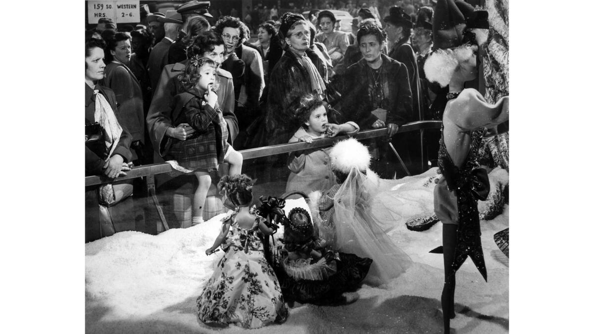 December 1949: Two little girls watch the animated Christmas activities in a downtown Los Angeles department store window. This photo was published in the Dec. 12, 1949, Los Angeles Times.