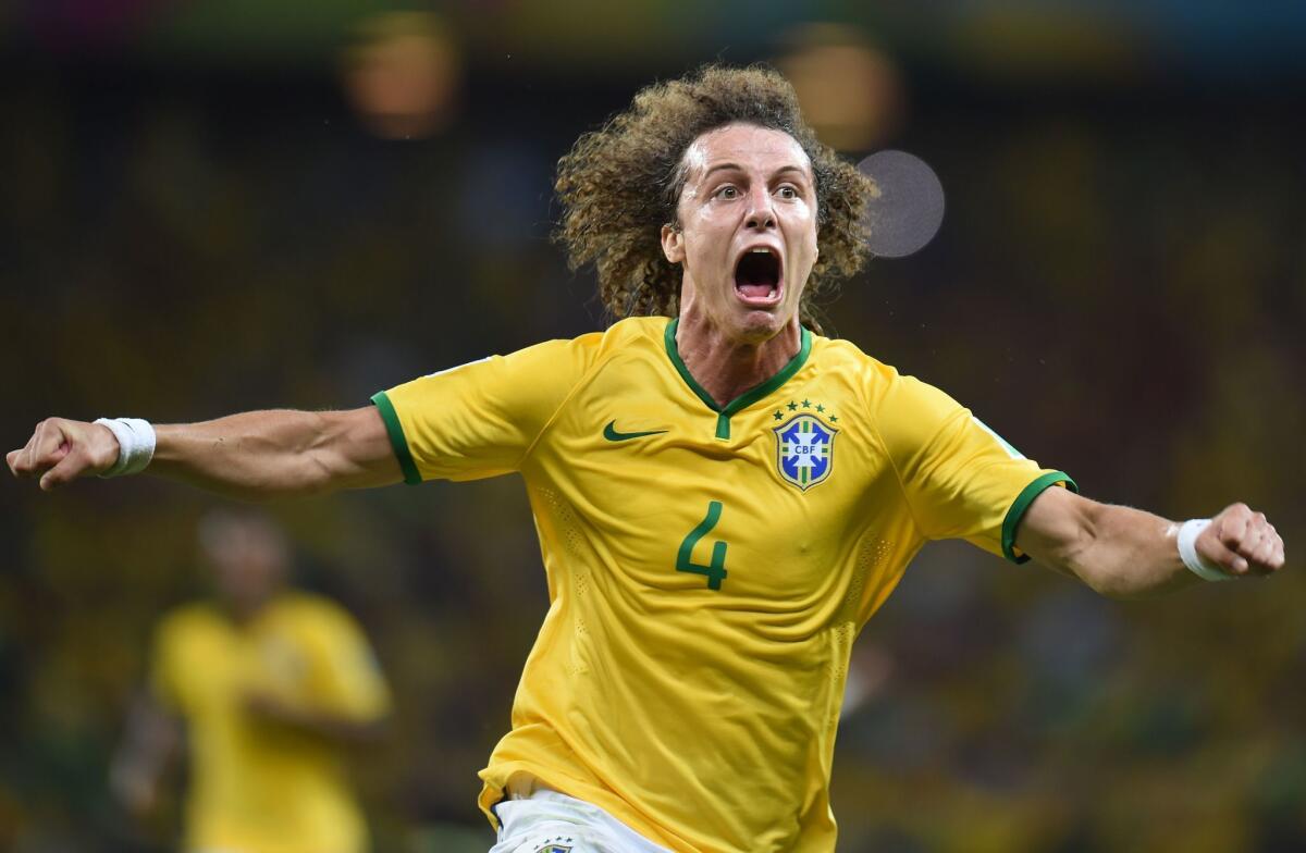 Brazil defender David Luiz celebrates after scoring on a free kick against Colombia in the second half of their World Cup quarterfinal game on Friday at Castelao Stadium in Fortaleza, Brazil.