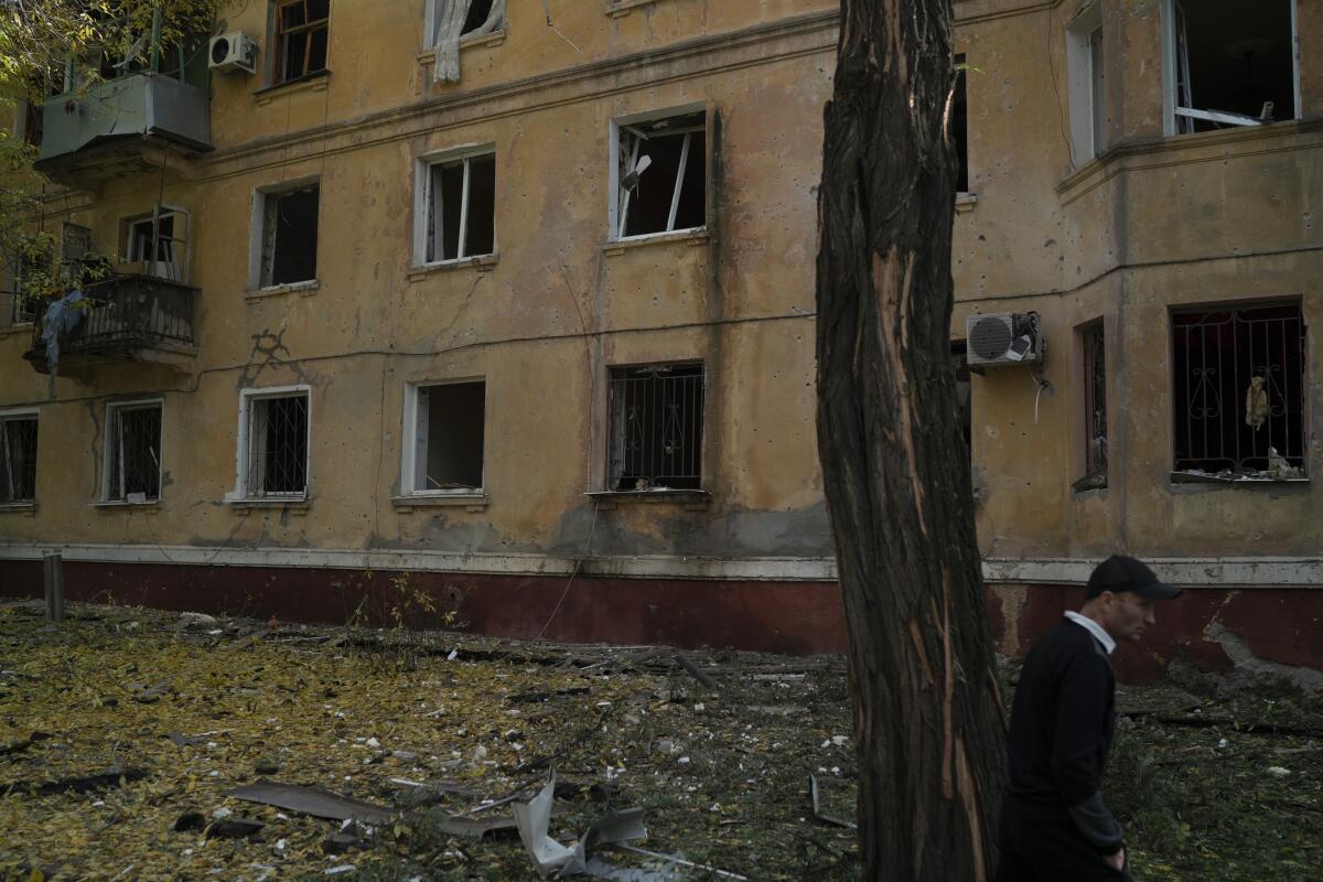 Man outside war-damaged building in Kramatorsk, Ukraine