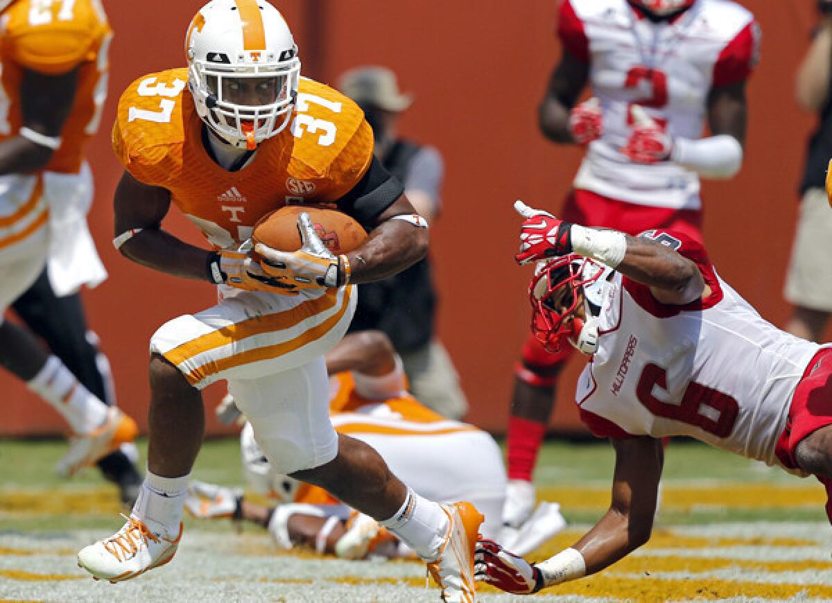 Tennessee defensive back Brian Randolph (37) avoids Western Kentucky receiver Joel German (6) after intercepting a pass in the second quarter Saturday.