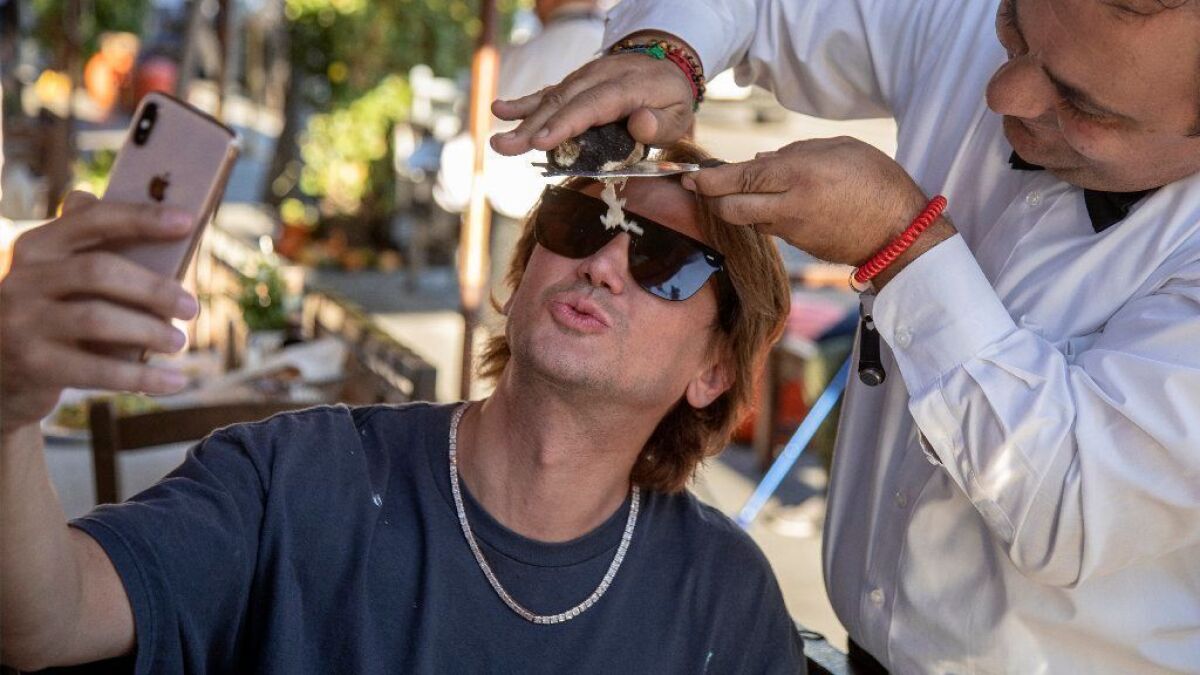 Jonathan Cheban, also known as Foodgod, getting a "truffle shower" at Il Pastaio in Beverly Hills.