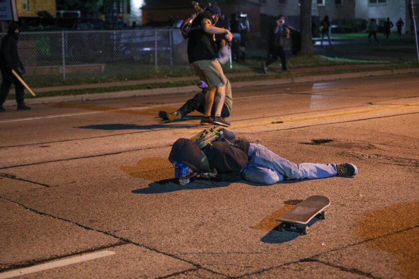KENOSHA, WISCONSIN, USA - AUGUST 25: A man on the ground was shot in the chest as clashes between protesters and armed civilians who protect the streets of Kenosha against the arson during the third day of protests over the shooting of a black man Jacob Blake by police officer in Wisconsin, United States on August 25, 2020. (Photo by Tayfun Coskun/Anadolu Agency via Getty Images)