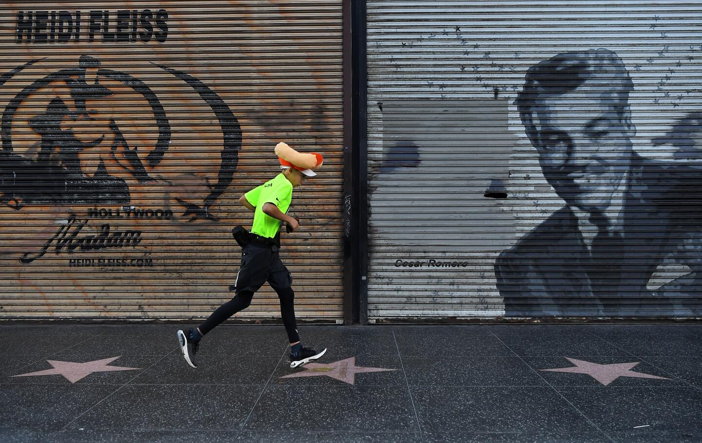 A competitor runs along Hollywood Blvd. in Hollywood Sunday during L.A. Marathon.