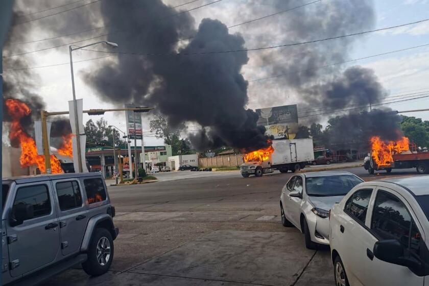 Mandatory Credit: Photo by STR/EPA-EFE/REX (10449104a) A view of vehicles on fire during a clash between armed gunmen and Federal police and military soldiers, in the streets of the city of Culiacan, Sinaloa state, Mexico, 17 October 2019. According to media reports, alleged drug cartel gunmen set up blockades and unleashed volleys of gunfire in the Mexican city of Culiacan amid rumors of the capture of Ovidio Guzman Lopez, son of imprisoned drug trafficker Joaquin 'El Chapo' Guzman Loera. The blockades set up by the gunmen, presumably from the Sinaloa drug cartel, extended to the exits of the city. Attempted capture of Ovidio Guzman Lopez sparks gunbattle in Culiacan, Mexico - 17 Oct 2019 ** Usable by LA, CT and MoD ONLY **