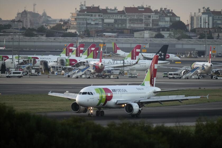 A TAP Air Portugal Airbus A310 lands in Lisbon at sunrise, Thursday, Sept. 28, 2023. Portugal's government is expected to announce Thursday that it is having another stab at privatizing flag carrier TAP Air Portugal. (AP Photo/Armando Franca)