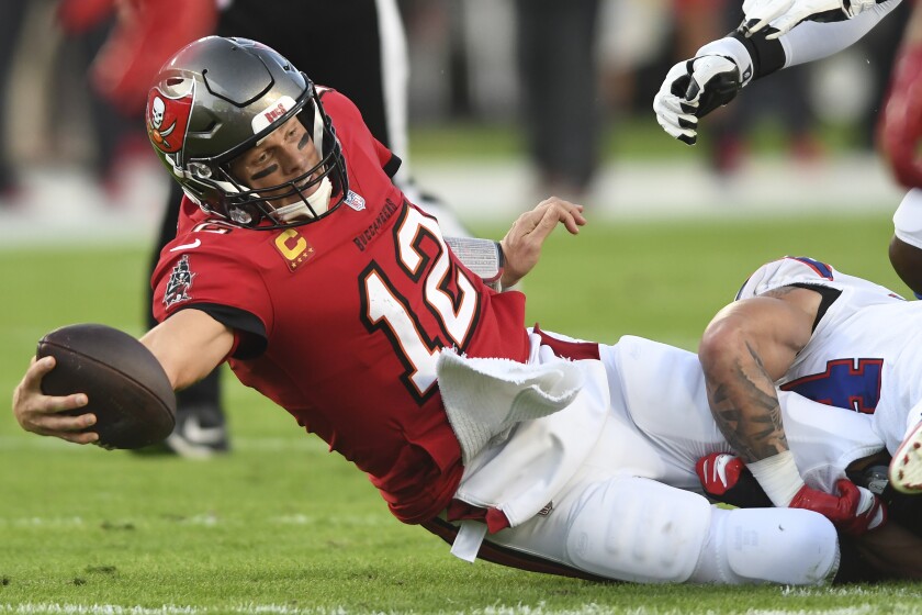 Tampa Bay Buccaneers quarterback Tom Brady (12) dives for a first down against the Buffalo Bills during the first half of an NFL football game Sunday, Dec. 12, 2021, in Tampa, Fla. (AP Photo/Jason Behnken)