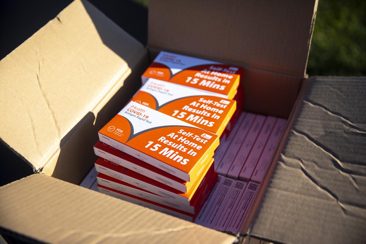 An open box with dozens of iHealth COVID-19 Rapid Test kits is shown in Redondo Beach.