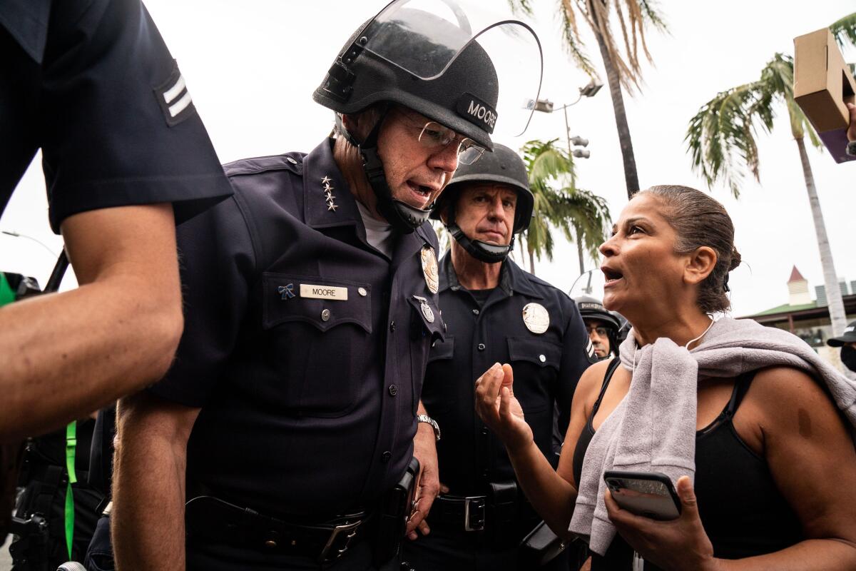 LAPD Chief of Police Michel Moore speaks with a protester in the Fairfax District.