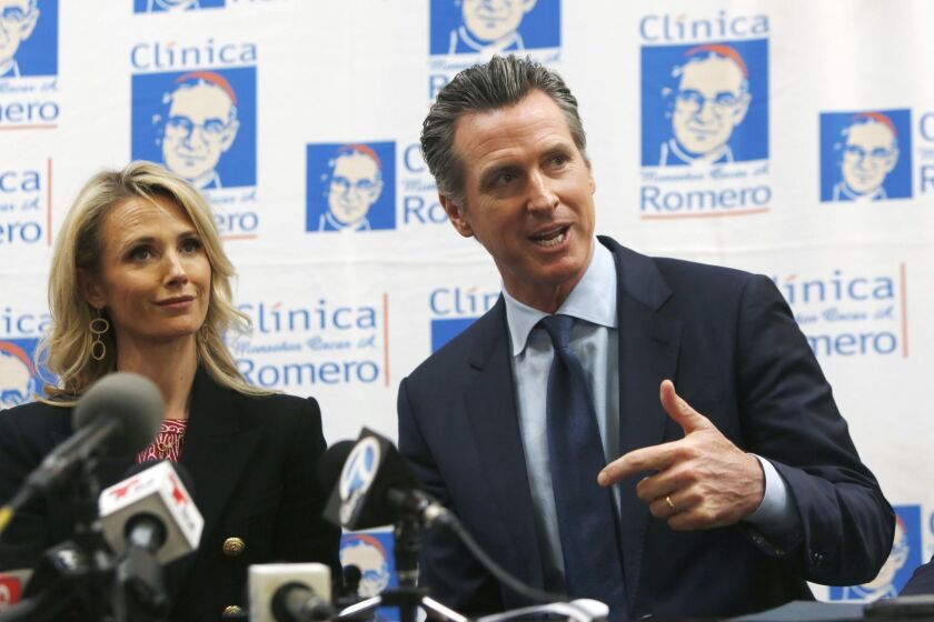 LOS ANGELES, CA-MARCH 28, 2019: Governor Gavin Newsom speaks with wife, Jennifer Siebel, left, during at a roundtable discussion at the ClÃnica MonseÃ±or Oscar A. Romero about Central American migration to Los Angeles and announce his upcoming visit to El Salvador on March 28, 2019, in Los Angeles, California. (Photo By Dania Maxwell / Los Angeles Times)