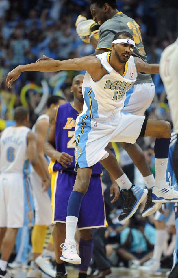 Nuggets forward Corey Brewer (13) celebrates with teammate Kenneth Faried after making a three-pointer against Kobe Bryant and the Lakers in the second half of Game 6 on Thursday night at the Pepsi Center in Denver.