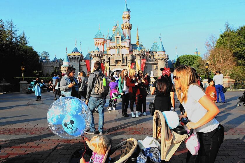 Disneyland guests enjoy a day at the park. A person ill with measles who was at the park triggered an outbreak across several states.