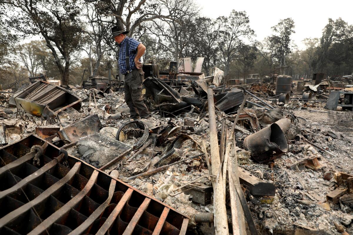 Ed Bledsoe surveys his Redding home, destroyed by the Carr fire.