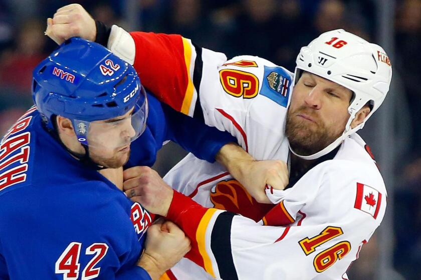 Calgary Flames forward Brian McGrattan, right, fights New York Rangers defenseman Dylan McIlrath during a game on Dec. 15, 2013.