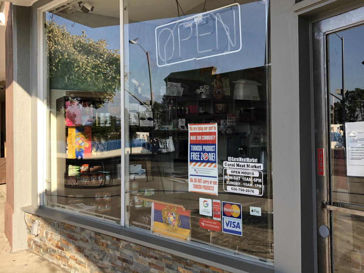 Signs in a window of a butcher shop