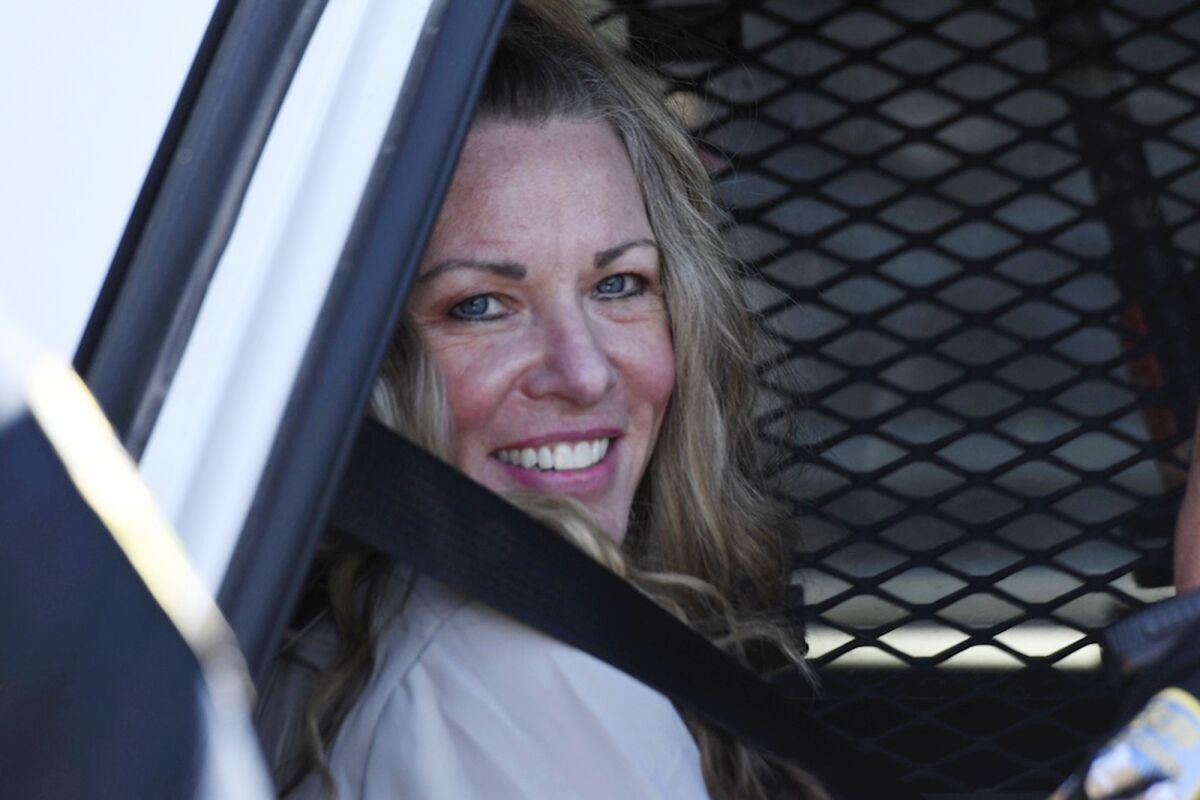 FILE - Lori Vallow Daybell sits in a police car after a hearing at the Fremont County Courthouse in St. Anthony, Idaho, on Aug. 16, 2022. Daybell who is charged with conspiracy and murder in connection with the deaths of her two kids and her new husband's late wife will no longer face the death penalty, a judge ruled Tuesday, March 21, 2023. She is scheduled to stand trial starting April 3. (Tony Blakeslee/East Idaho News via AP, Pool, File)