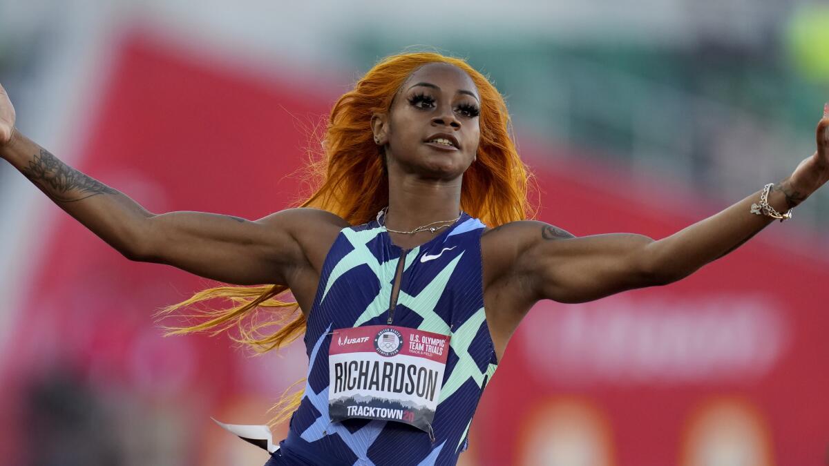 Sha'Carri Richardson celebrates after winning her heat of the women's 100 meters run at the U.S. Olympic trials last month