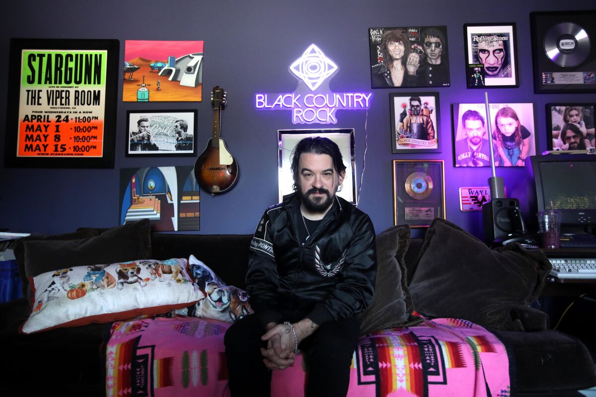 A music producer on a couch in his studio
