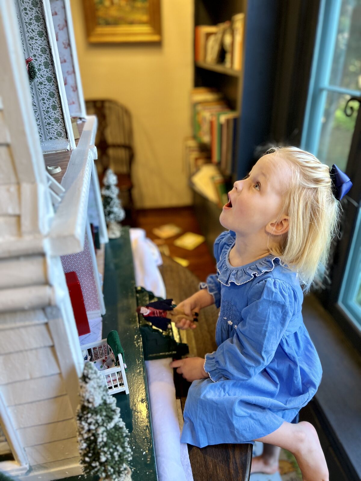 A Geier grandchild checks out the newly restored dollhouse.