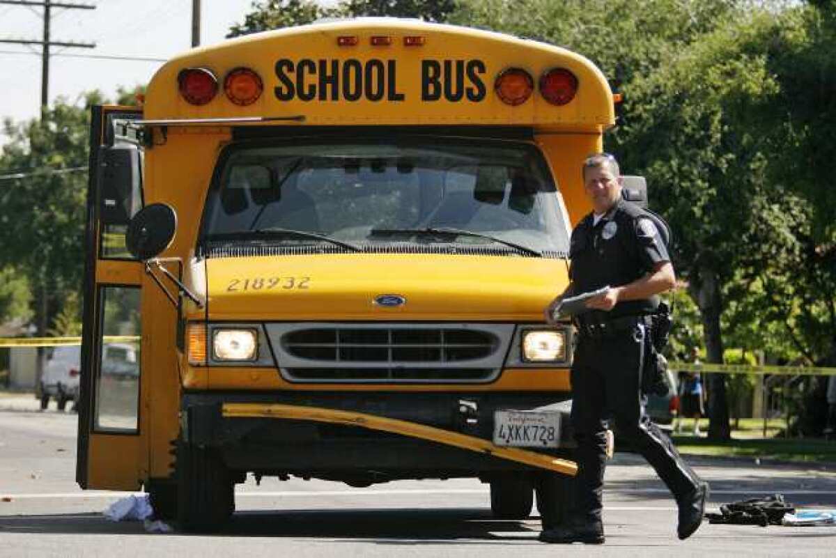 Glendale Police investigate an accident on S. Columbus Avenue and Riverdale Drive in Glendale on Thursday, May 2, 2013. A 14-year-old boy died Thursday after he was struck by, and then trapped underneath, a school bus, police said.